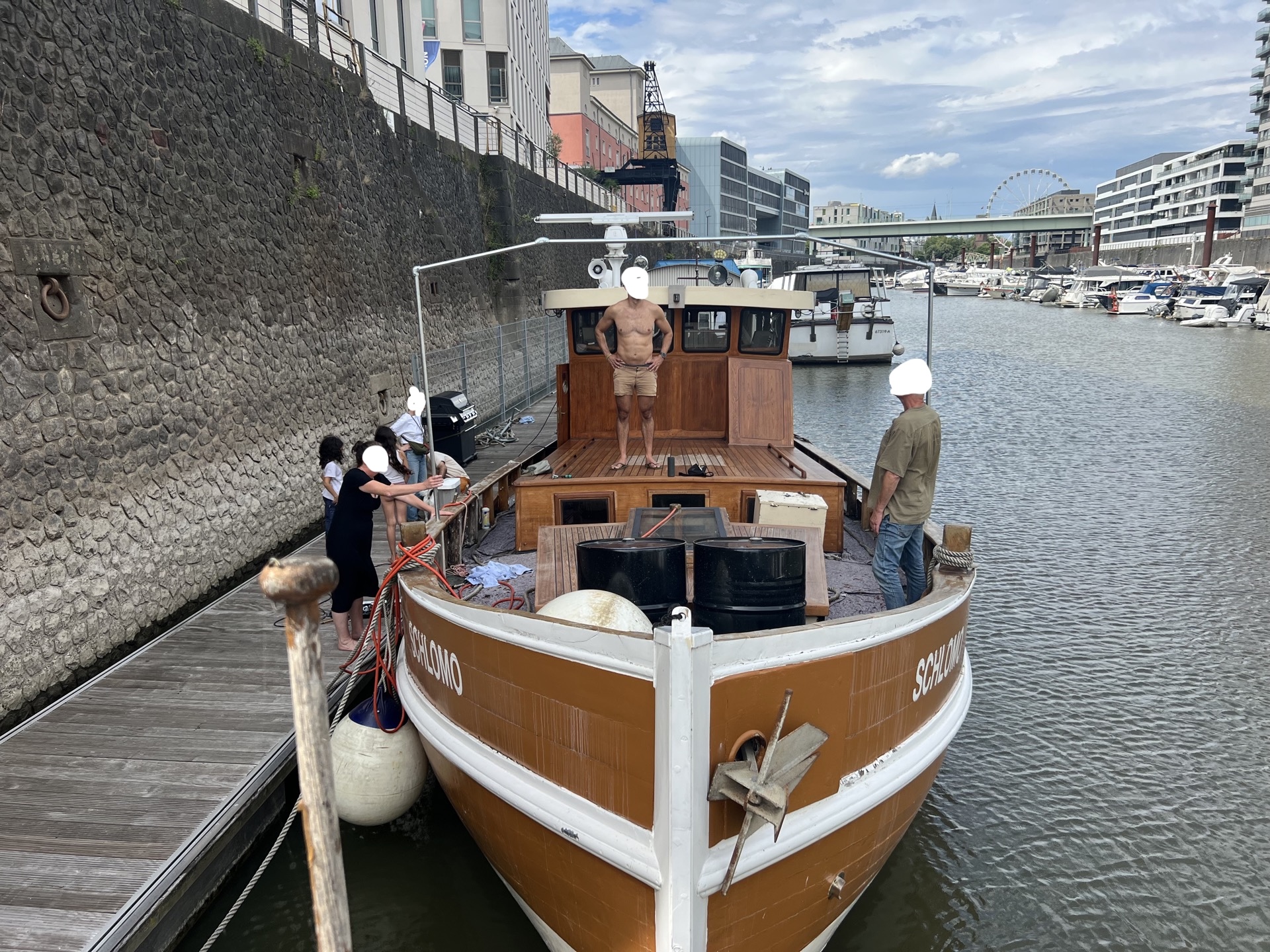 Schlomo deck — people aboard, Ferris wheel and harbor